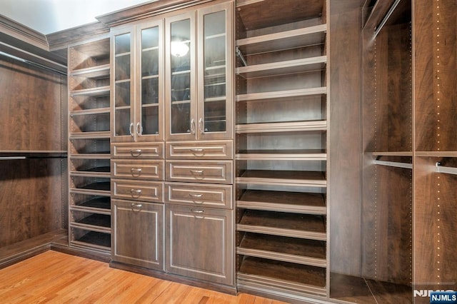 walk in closet featuring light wood finished floors