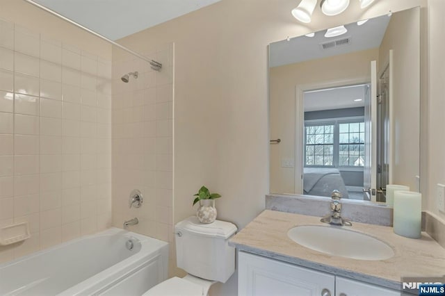 full bathroom featuring visible vents, toilet, ensuite bath, vanity, and shower / bathing tub combination