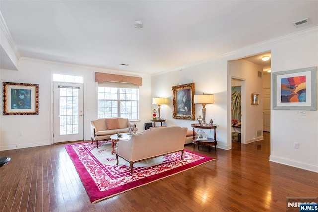 living room featuring dark wood-type flooring, visible vents, crown molding, and baseboards