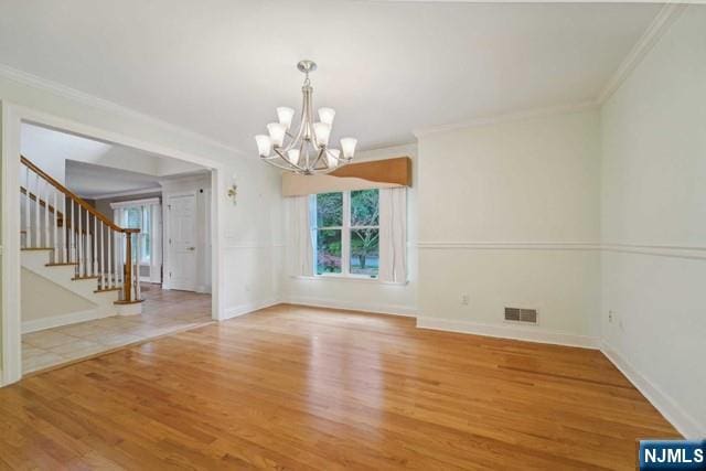 interior space with visible vents, crown molding, stairway, and wood finished floors