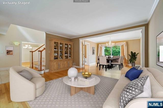 living room featuring baseboards, stairway, ornamental molding, wood finished floors, and a notable chandelier