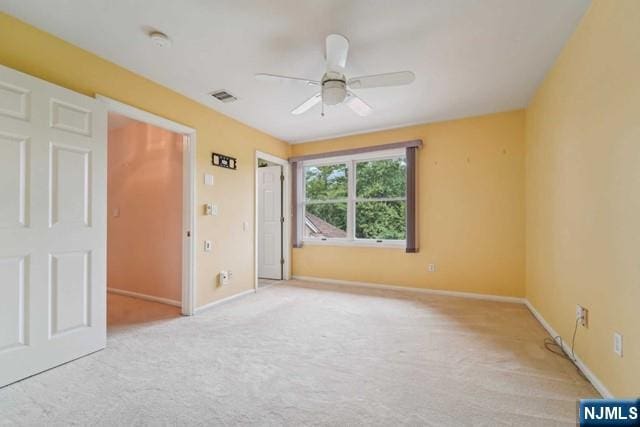 unfurnished bedroom with carpet, visible vents, ceiling fan, and baseboards