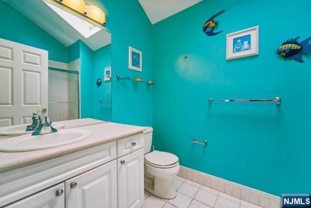 bathroom with toilet, lofted ceiling with skylight, a shower with shower door, tile patterned flooring, and vanity