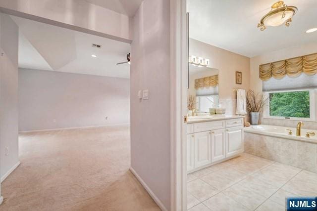 bathroom with a garden tub, recessed lighting, vanity, tile patterned flooring, and baseboards