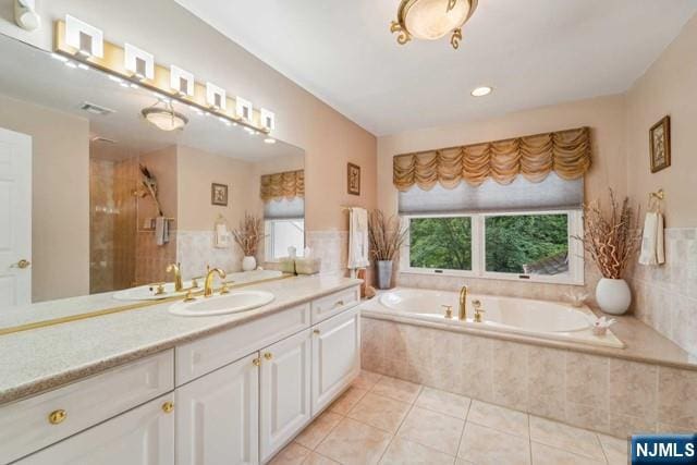 full bath with visible vents, tile patterned floors, a garden tub, an enclosed shower, and vanity