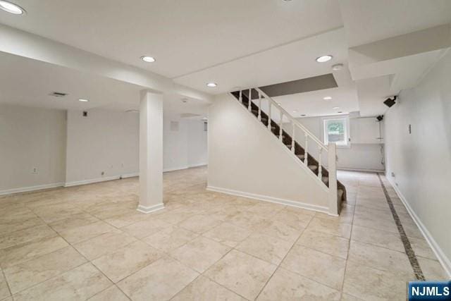 below grade area with recessed lighting, light tile patterned flooring, stairway, and baseboards