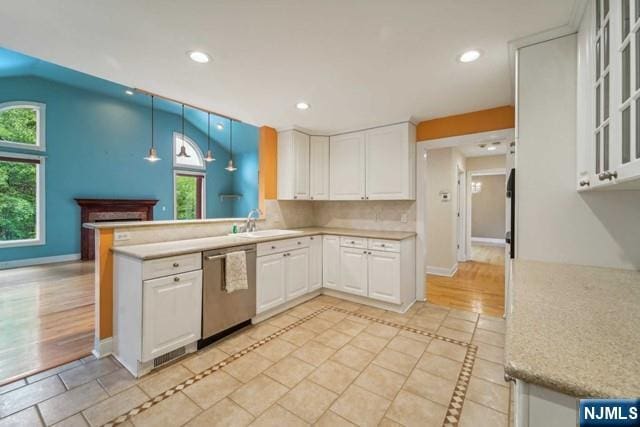 kitchen with a sink, white cabinetry, stainless steel dishwasher, and recessed lighting