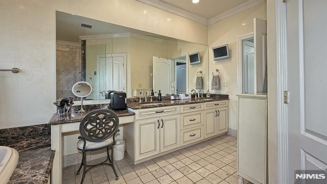 bathroom with double vanity, ornamental molding, and a sink