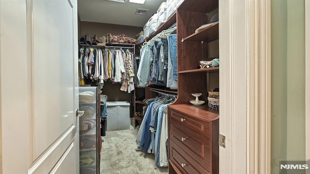 spacious closet featuring carpet flooring and visible vents