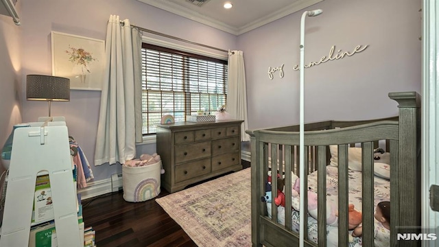 bedroom with recessed lighting, wood finished floors, visible vents, a crib, and crown molding