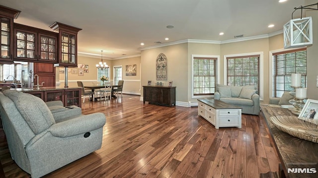 living area featuring crown molding, dark wood finished floors, a notable chandelier, recessed lighting, and visible vents