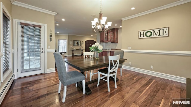 dining space with arched walkways, ornamental molding, baseboard heating, and dark wood finished floors