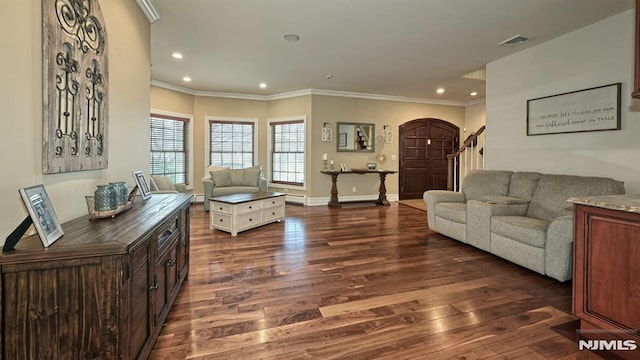 living room featuring arched walkways, dark wood-type flooring, visible vents, baseboards, and ornamental molding