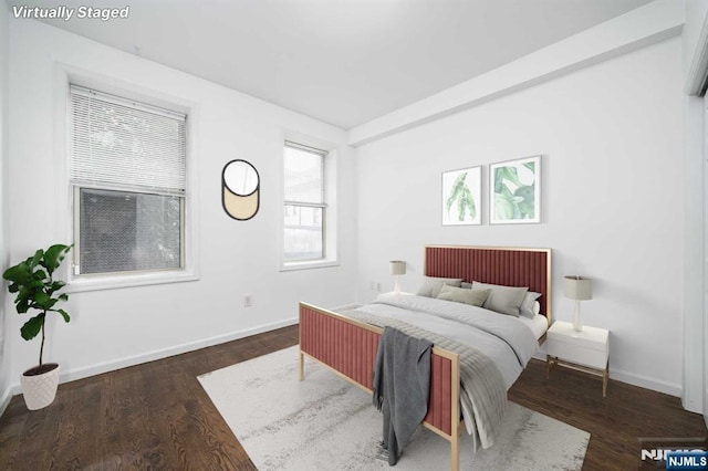 bedroom featuring baseboards and wood finished floors