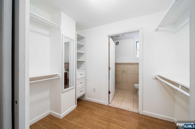 spacious closet with light wood-style flooring