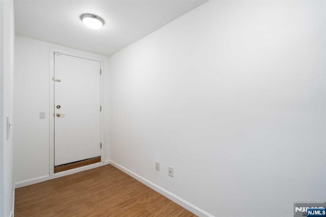 interior space with baseboards and light wood finished floors