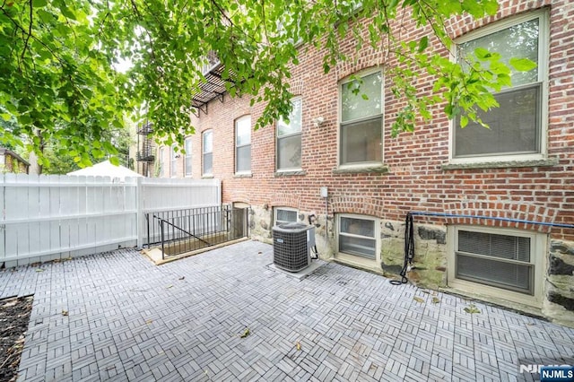 view of patio / terrace with fence and central AC unit