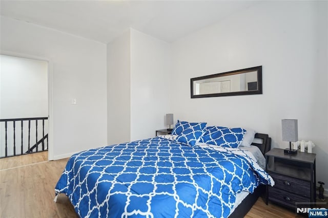 bedroom featuring baseboards and wood finished floors