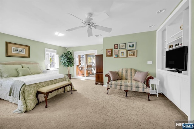 carpeted bedroom with visible vents and ceiling fan