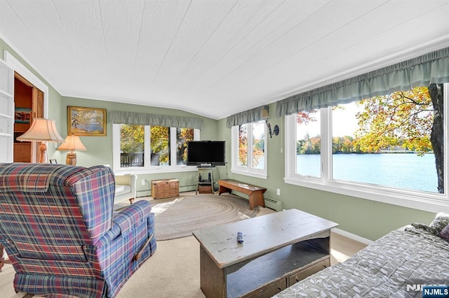 carpeted living area with baseboard heating, vaulted ceiling, and baseboards