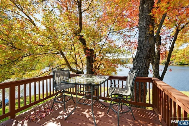 wooden terrace featuring a water view