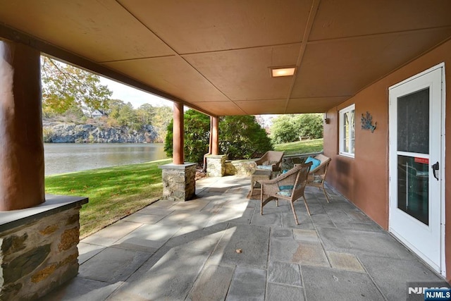 view of patio featuring a water view