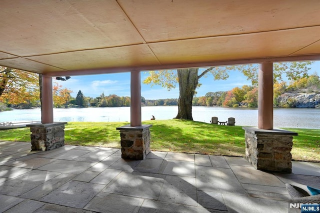 view of patio with a water view