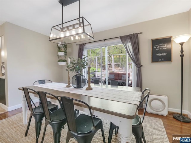 dining space with wood finished floors and baseboards