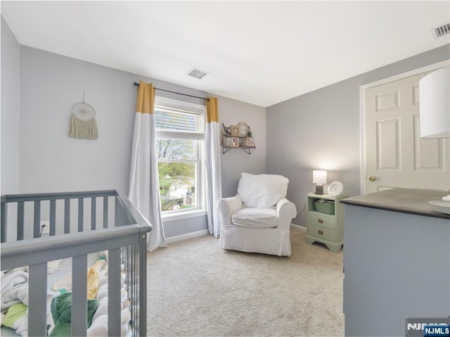 bedroom featuring light carpet, visible vents, and baseboards