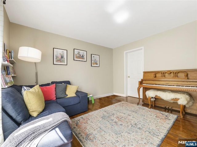 living area featuring dark wood-style floors and baseboards