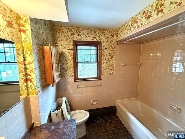 full bath featuring wallpapered walls, toilet, a wainscoted wall, tile patterned floors, and tile walls