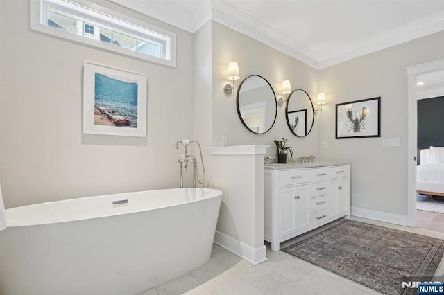 ensuite bathroom with baseboards, a sink, connected bathroom, and crown molding