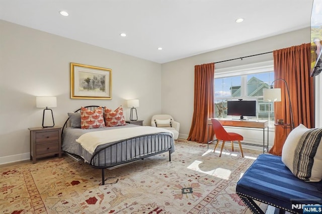 bedroom with baseboard heating, recessed lighting, and baseboards