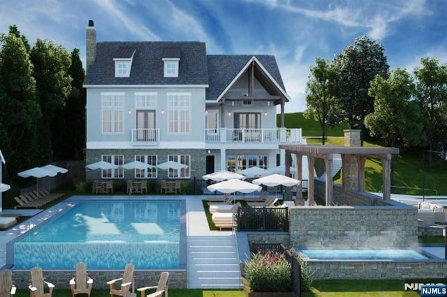 rear view of property featuring a chimney, a balcony, and an outdoor pool