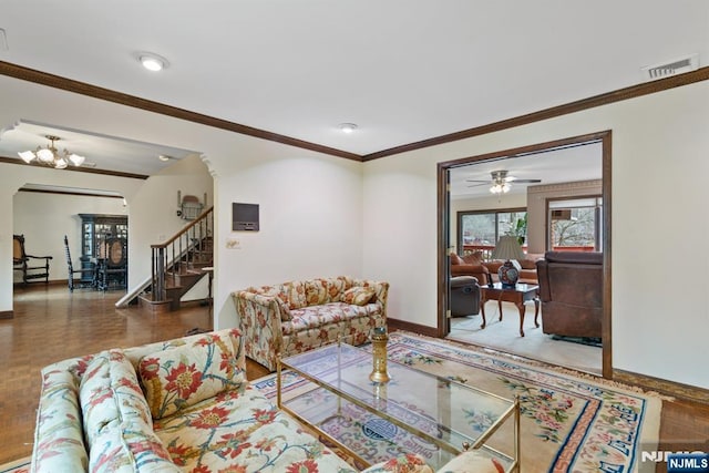 living room featuring visible vents, baseboards, stairs, ornamental molding, and an inviting chandelier