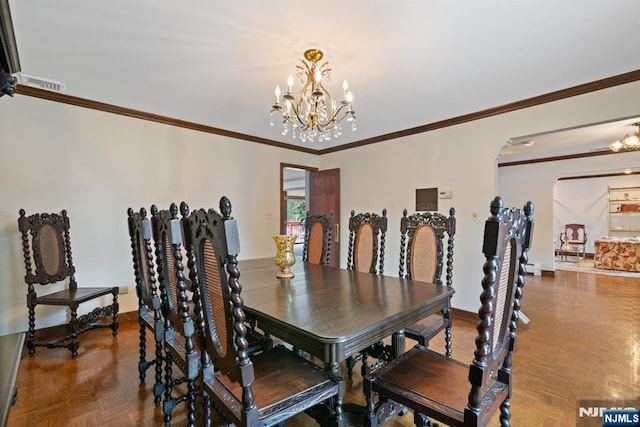 dining space with visible vents, arched walkways, baseboards, ornamental molding, and an inviting chandelier