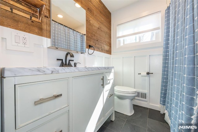 bathroom with visible vents, wainscoting, toilet, tile patterned floors, and vanity