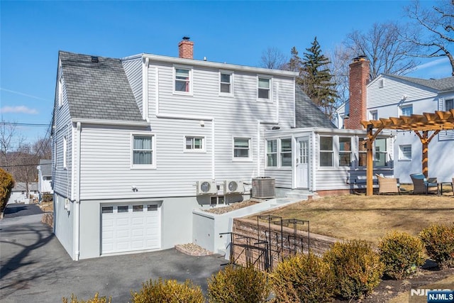 back of property featuring a chimney, central air condition unit, an attached garage, fence, and a pergola