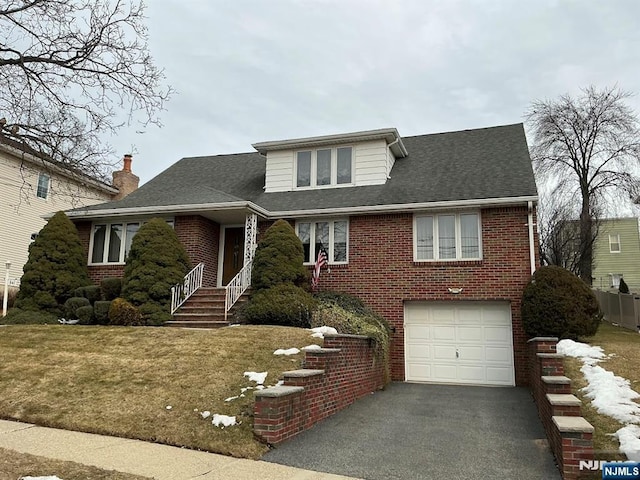 view of front facade featuring driveway, a garage, a shingled roof, a front lawn, and brick siding