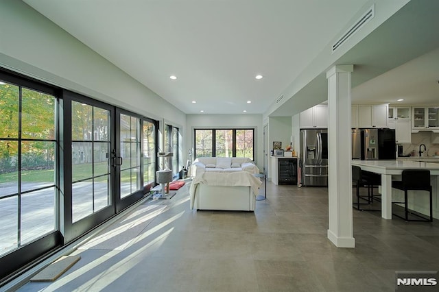 interior space featuring beverage cooler, visible vents, recessed lighting, stainless steel fridge with ice dispenser, and fridge with ice dispenser