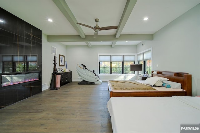 bedroom with visible vents, beam ceiling, wood finished floors, recessed lighting, and baseboards