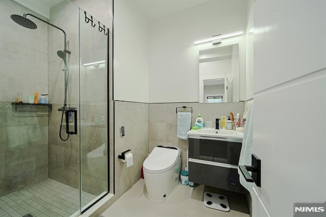 full bathroom with toilet, tile walls, a stall shower, and vanity