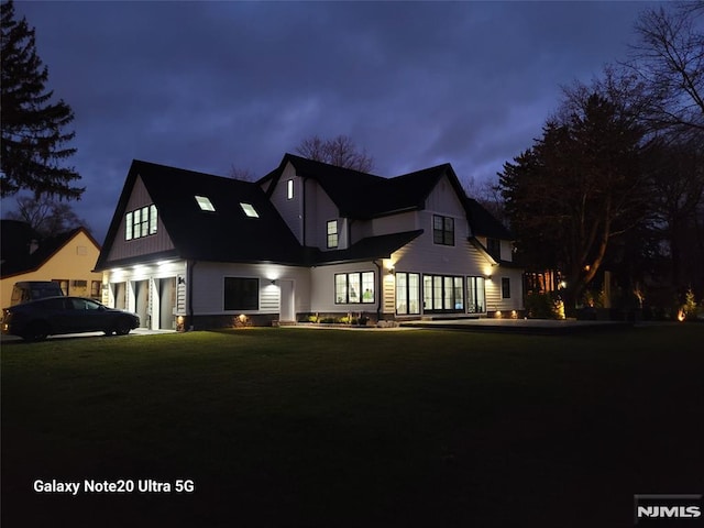 modern farmhouse featuring a front lawn and a garage