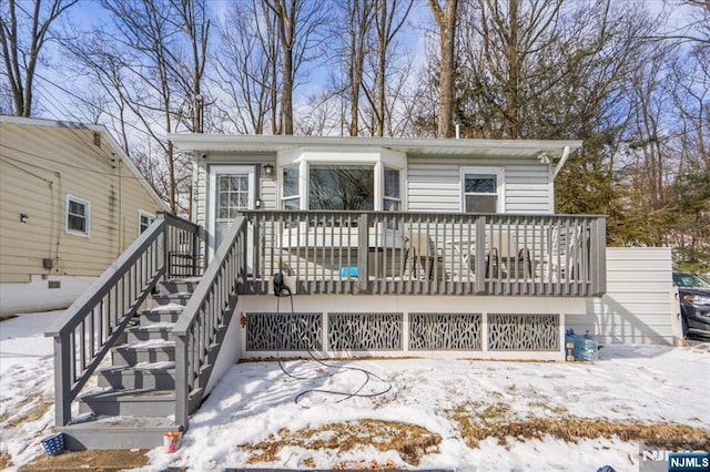 view of front of house featuring a deck and stairway