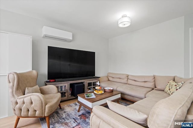 living area featuring a wall unit AC and wood finished floors