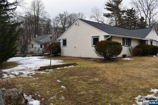 snow covered property with a yard