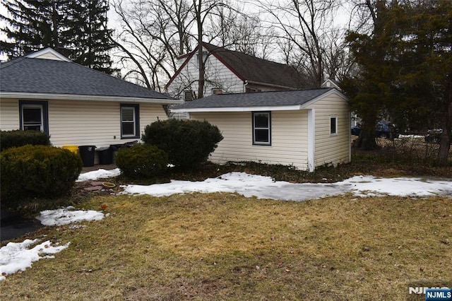 view of snowy exterior with a yard