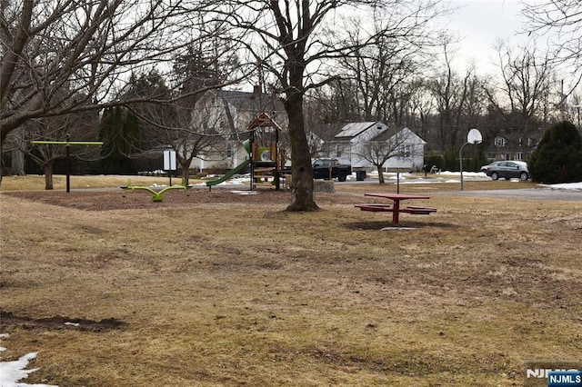 surrounding community featuring playground community and a lawn