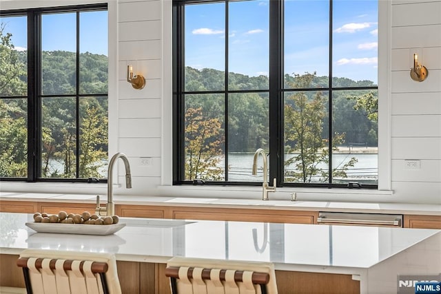 kitchen with a sink, brown cabinets, and light countertops