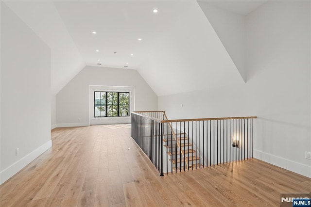 bonus room featuring vaulted ceiling, light wood-style flooring, recessed lighting, and baseboards